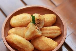 Comro or combro, a traditional Javanese snack made of deep fried grated cassava filled with a savory mix of oncom or fermented soy bean cake and chili photo