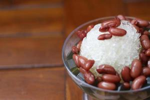 Es Kacang Merah or a cold drink made from red beans boiled with brown sugar served with coconut milk, shaved ice and covered with sweetened condensed milk chocolate and syrup. photo