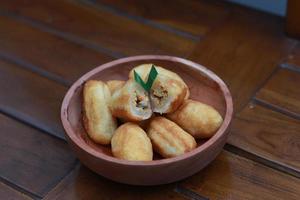 Comro or combro, a traditional Javanese snack made of deep fried grated cassava filled with a savory mix of oncom or fermented soy bean cake and chili photo