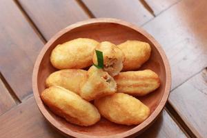 Comro or combro, a traditional Javanese snack made of deep fried grated cassava filled with a savory mix of oncom or fermented soy bean cake and chili photo