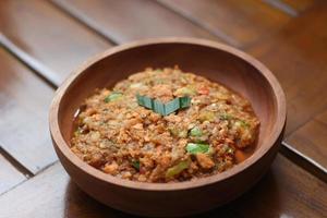 a close up Rujak Bebek or smashed fruit which is made from raw fruit crushed in a mortar and pestle and added with shrimp paste, chili and brown sugar. Indonesian traditional food photo concept.