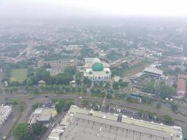 aerial view of the Darusalam mosque on the side of the highway. photo