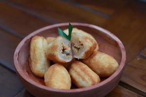 Comro or combro, a traditional Javanese snack made of deep fried grated cassava filled with a savory mix of oncom or fermented soy bean cake and chili photo