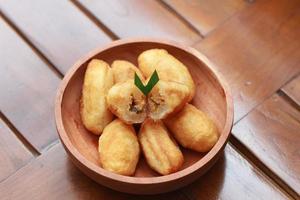 Comro or combro, a traditional Javanese snack made of deep fried grated cassava filled with a savory mix of oncom or fermented soy bean cake and chili photo