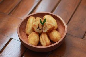 Comro or combro, a traditional Javanese snack made of deep fried grated cassava filled with a savory mix of oncom or fermented soy bean cake and chili photo