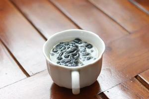 a close up of a glass of a traditional Indonesian drink called Dawet Ireng or black dawet. Indonesian traditional food photo concept.