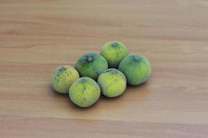 greenish yellow harp fruit isolated on money table has sweet and sour taste. Food concept photo. photo