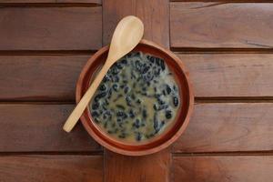 a close up of a bowl of traditional Indonesian drink called Dawet Ireng or black dawet. Indonesian traditional food photo concept.