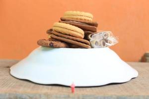 miniature figure of a child looking up at the mountains made of a plate and some cakes. photo