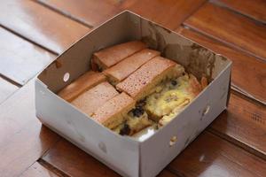 a dish called sweet martabak topped with raisins and bananas tastes sweet and is filling. made from flour dough. served warm. Food concept photo. photo