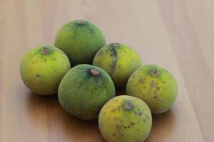 greenish yellow harp fruit isolated on money table has sweet and sour taste. Food concept photo. photo