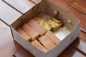 a dish called sweet martabak topped with raisins and bananas tastes sweet and is filling. made from flour dough. served warm. Food concept photo. photo