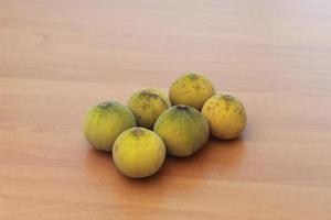 greenish yellow harp fruit isolated on money table has sweet and sour taste. Food concept photo. photo