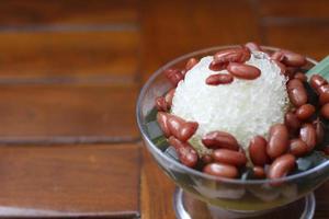 Es Kacang Merah or a cold drink made from red beans boiled with brown sugar served with coconut milk, shaved ice and covered with sweetened condensed milk chocolate and syrup. photo