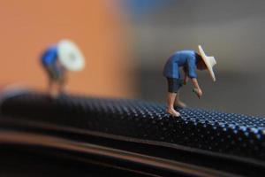 miniature figures of farmers at work on a switchblade comb. concept of agriculture photo. photo