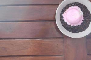 close up of a bowl of black sticky rice porridge photo