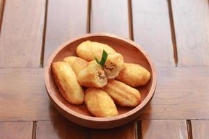 Comro or combro, a traditional Javanese snack made of deep fried grated cassava filled with a savory mix of oncom or fermented soy bean cake and chili photo