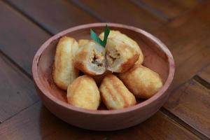 Comro or combro, a traditional Javanese snack made of deep fried grated cassava filled with a savory mix of oncom or fermented soy bean cake and chili photo