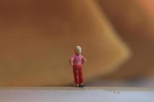 miniature figure of a child looking up at the mountains made of a plate and some cakes. photo