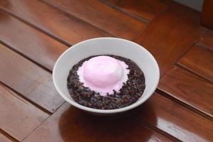 close up of a bowl of black sticky rice porridge photo