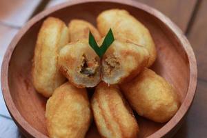 Comro or combro, a traditional Javanese snack made of deep fried grated cassava filled with a savory mix of oncom or fermented soy bean cake and chili photo