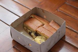 a dish called sweet martabak topped with raisins and bananas tastes sweet and is filling. made from flour dough. served warm. Food concept photo. photo