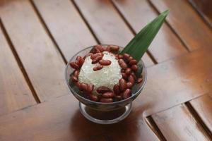 Es Kacang Merah or a cold drink made from red beans boiled with brown sugar served with coconut milk, shaved ice and covered with sweetened condensed milk chocolate and syrup. photo