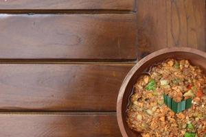 a close up Rujak Bebek or smashed fruit which is made from raw fruit crushed in a mortar and pestle and added with shrimp paste, chili and brown sugar. Indonesian traditional food photo concept.