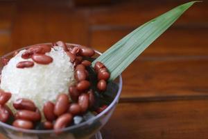 Es Kacang Merah or a cold drink made from red beans boiled with brown sugar served with coconut milk, shaved ice and covered with sweetened condensed milk chocolate and syrup. photo