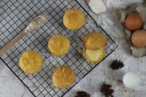 a traditional cake from Indonesia called kue sus filled with cream puffs. served on a cake rack. Food concept photo. photo