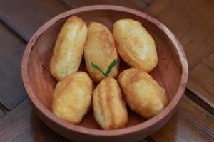 Comro or combro, a traditional Javanese snack made of deep fried grated cassava filled with a savory mix of oncom or fermented soy bean cake and chili photo