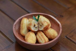 Comro or combro, a traditional Javanese snack made of deep fried grated cassava filled with a savory mix of oncom or fermented soy bean cake and chili photo