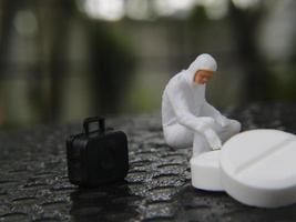 a close up of a miniature figure of a researcher researching a drug. health photo concept.