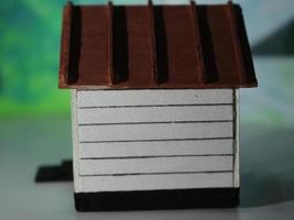 a close up of a miniature figure of a house seen from one side. simple home photo concept.