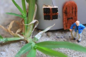 miniature figure of a grandfather who is waiting in front of the house. photo