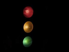 traffic light red yellow green isolated on black photo