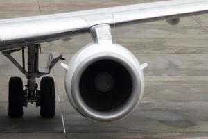 engine detail of airplane while parking at the terminal photo