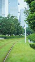 The tram view with the green trees and iron trail in the city photo
