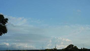 The summer sky view with the white clouds and blue sky as background photo