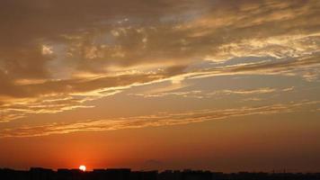 The beautiful sunset sky view with the colorful clouds and warm lights in the sky photo