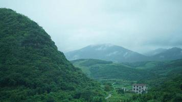 The beautiful countryside view from the runny train on the south of the China in the rainy day photo