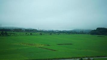 The beautiful countryside view from the runny train on the south of the China in the rainy day photo