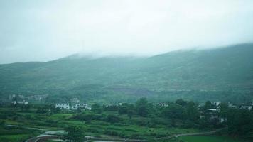 The beautiful countryside view from the runny train on the south of the China in the rainy day photo