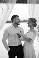 bride and groom against the backdrop of a yellow sunset photo