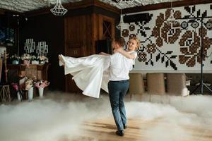 the first dance of the bride and groom inside a restaurant photo