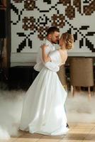 the first dance of the bride and groom inside a restaurant photo