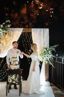 newlyweds happily cut and taste the wedding cake photo