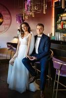 bride and groom inside a cocktail bar photo