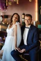 bride and groom inside a cocktail bar photo