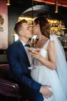 bride and groom inside a cocktail bar photo